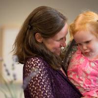 A woman holding a little girl.
